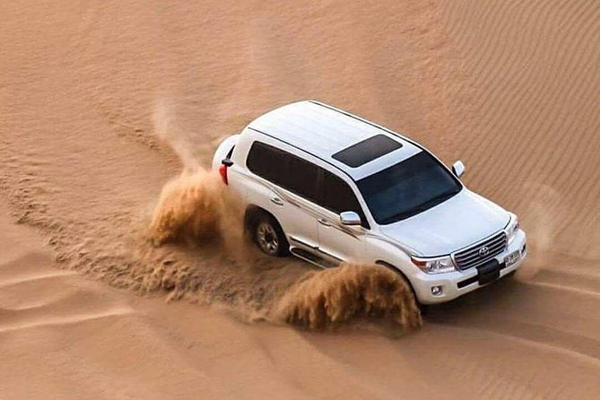 Doha :Half Day Desert Safari | Camel Riding | ATV | Sand Surfing - Sealine Beach: tea, camels, and a quick first stop