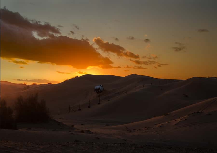 Doha: Sunset Safari, Dune Bashing, Sandboarding & Camel Ride - Dune bashing in a 4x4