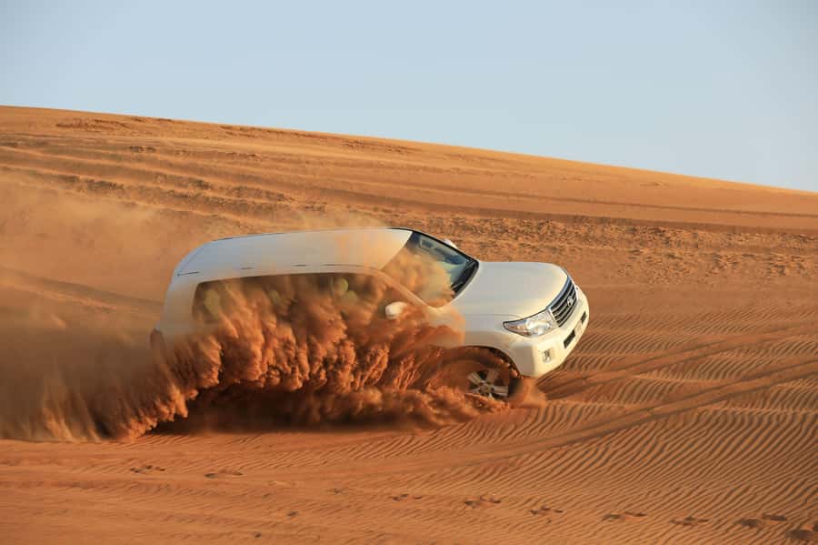 Dubai: Desert Safari, Quad Bike, Sandboarding, Camels & BBQ - Sunset photos, falcons and Arabic hospitality