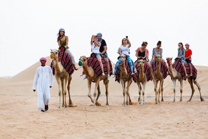 Dubai Desert Safari with Quads, BBQ Dinner, Camel ride, & Shows - Dune bashing across the sandy slopes