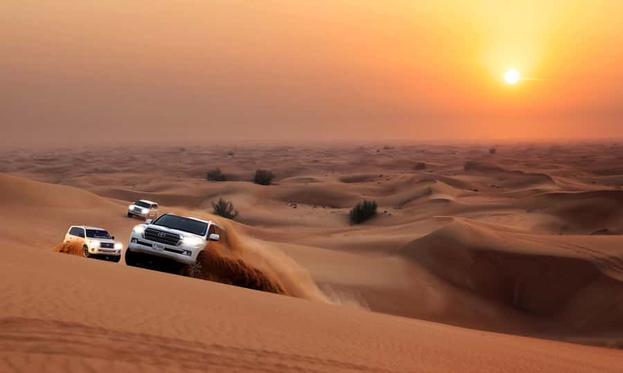Dubai: Red Dune Desert Safari, Quad Bike, Camels, and BBQ - Dune bashing across the red sand