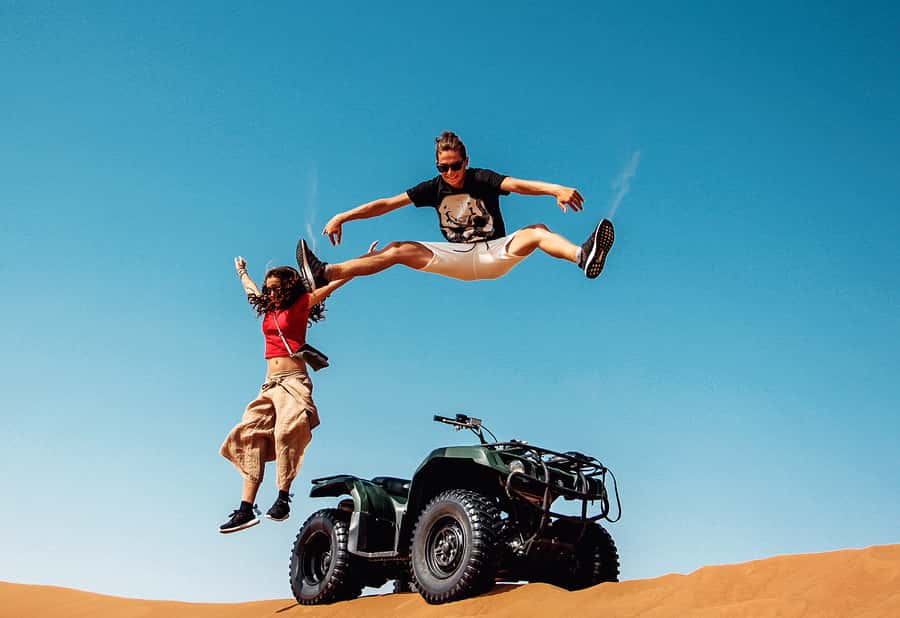 Dubai: Red Dunes Quad Bike with Sandboarding, Camels and BBQ - Sandboarding and the pause between activities